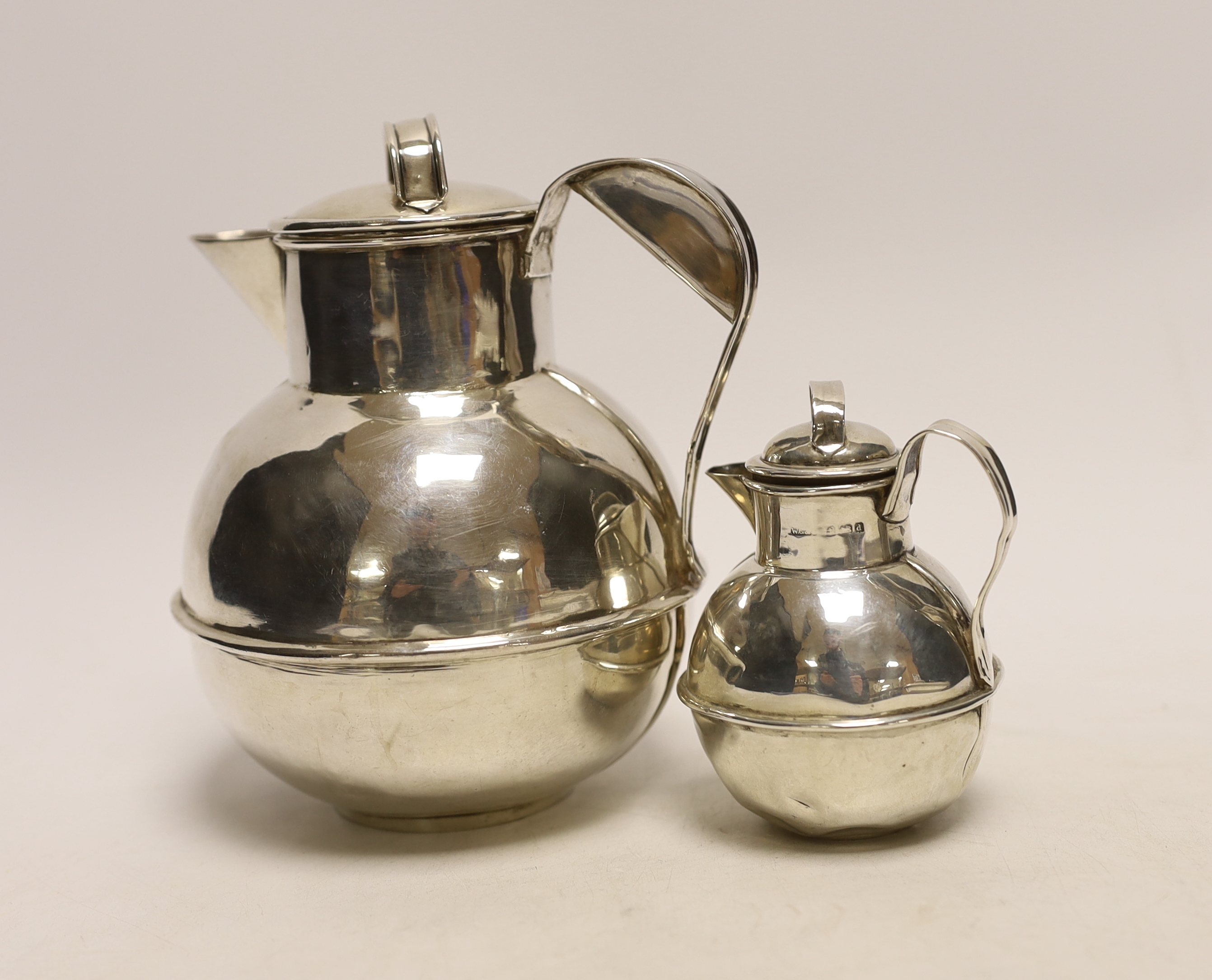 A late Victorian silver 'Guernsey' milk can, retailed by Roger of Guernsey, Chester, 1900, 15.5cm and a smaller silver milk can, Birmingham, 1903, 7.6oz.